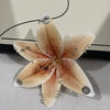 A realistic Phalaenopsis orchid flower shaped keychain with delicate petals and a central structure.