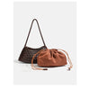 A brown handwoven PU shoulder bag with a woven texture and leather-like drawstring closure is displayed on a light background