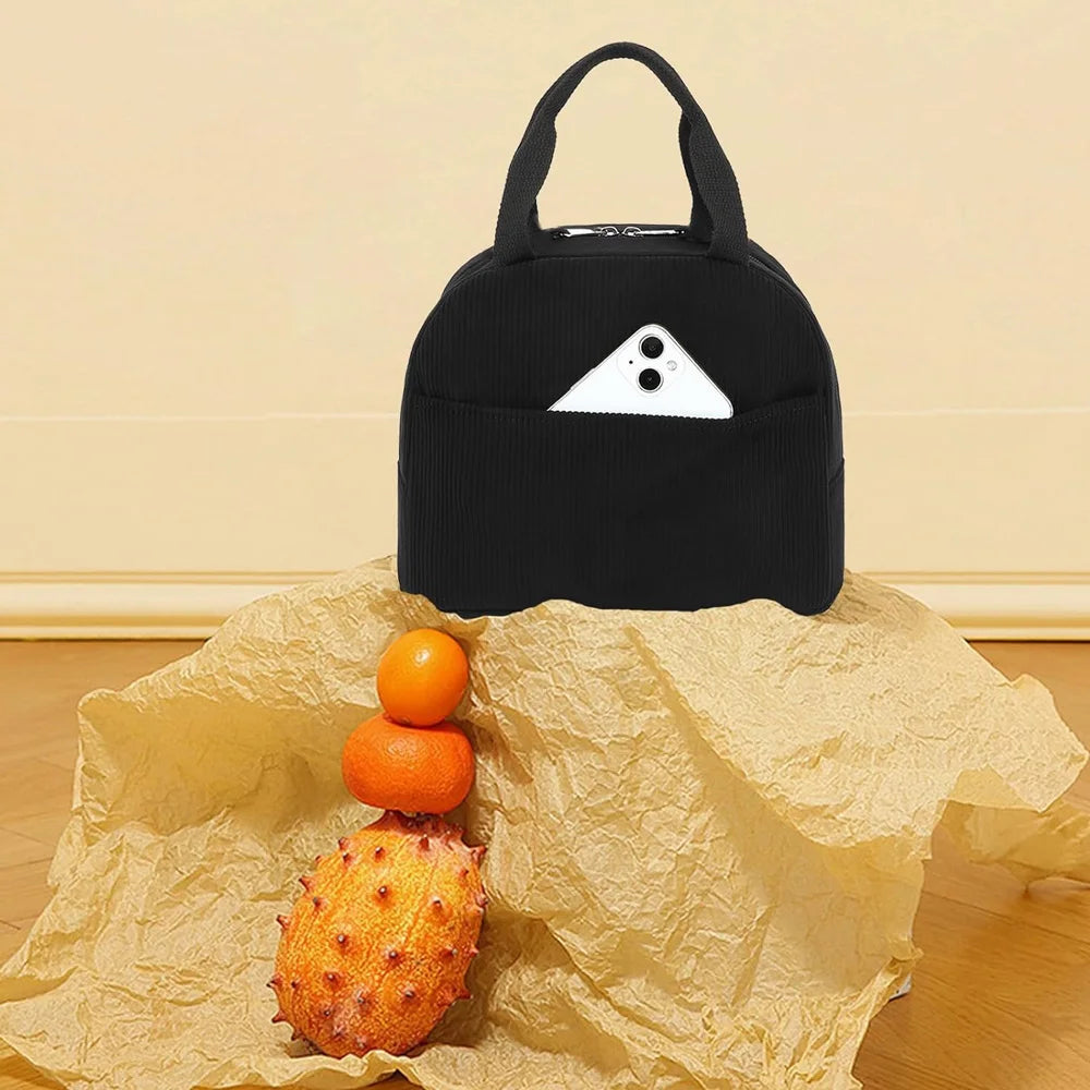 Black reusable thermal insulated bento bag with a triangular window, resting on crumpled brown paper.