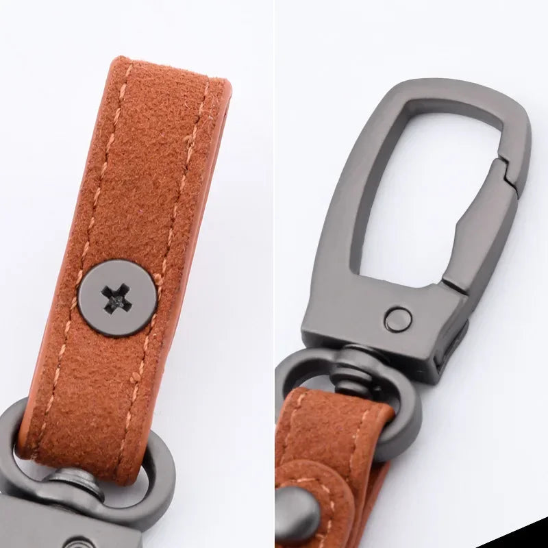 A close-up view of a genuine leather keyring keychain with a brown leather strap and a silver metal clasp.