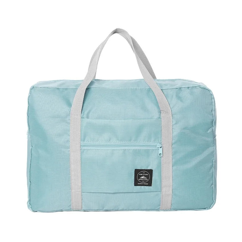 Sac de voyage pliable bleu clair avec sangles gris clair et étiquette noire