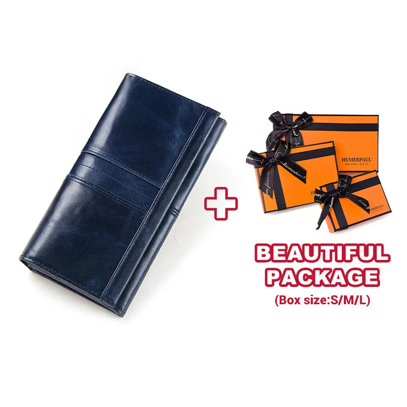 A dark blue genuine leather clutch wallet is shown next to an orange gift box, emphasizing a beautiful package.
