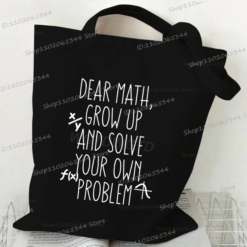Black canvas tote bag featuring white text that reads Dear Math Grow Up and Solve Your Own Problem