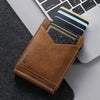 A brown PU leather card holder with a black card and a blue card is shown next to a laptop keyboard.