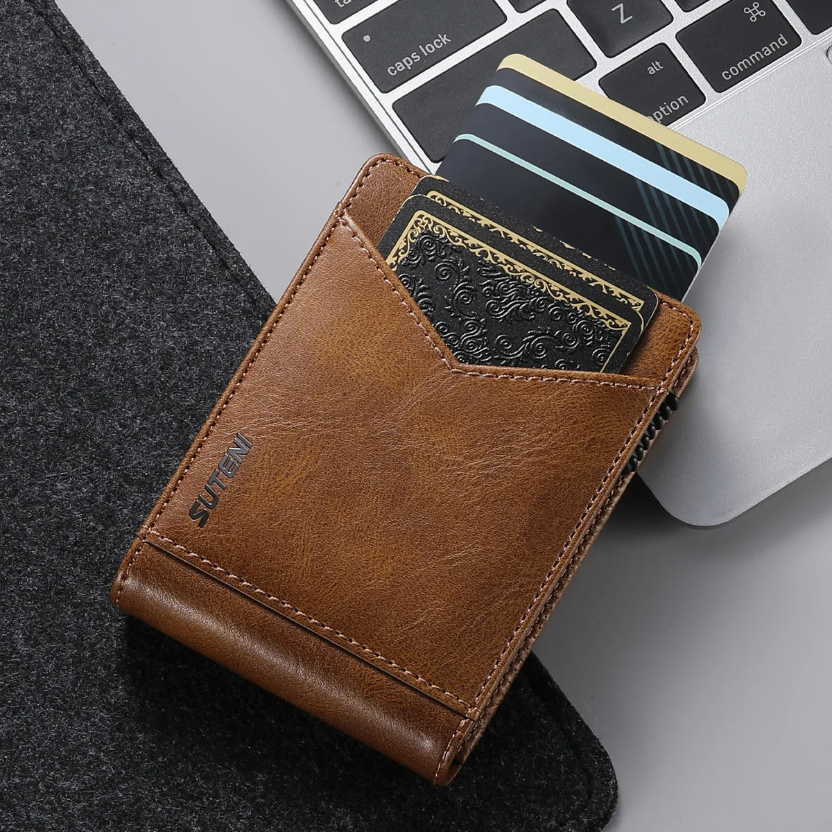 A brown PU leather card holder with a black card and a blue card is shown next to a laptop keyboard.