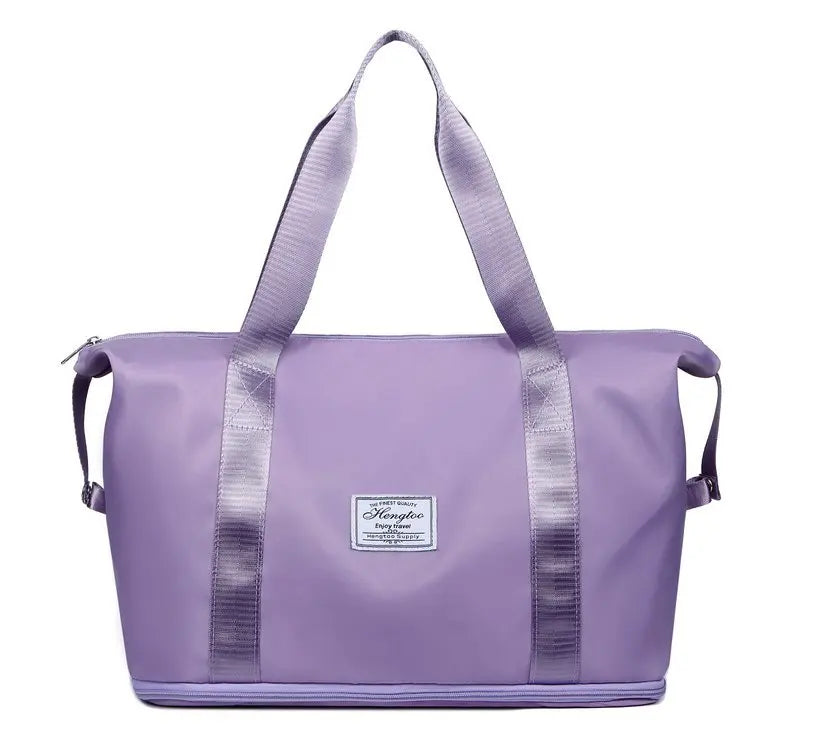 A purple expandable travel organizer bag with light gray straps and accents.