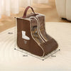 A brown portable waterproof boot storage bag with a clear window displaying a white boot, shown on a light rug.
