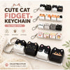 A collection of cute cat fidget keychains and bag charms in white and black designs.
