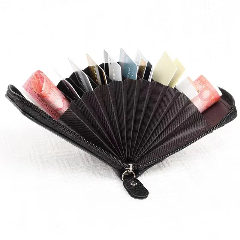 A black card holder wallet with multiple slots displaying various credit cards and IDs.