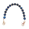 Handcrafted resin stone bead necklace featuring deep blue beads on a gold-toned chain.