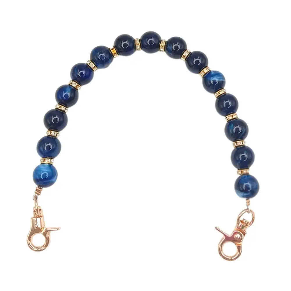 Handcrafted resin stone bead necklace featuring deep blue beads on a gold-toned chain.