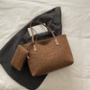 A brown leopard print tote bag resting on a dark gray blazer or jacket.