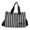 Sac bandoulière en toile rayée noir et beige avec anses sombres.