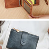 A brown leather foldable wallet is shown being held and opened to display multiple cards.