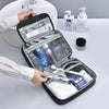 A portable PU leather cosmetic organizer bag is open, displaying various grooming products and toiletries on a white surface.