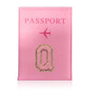 A pink leather passport holder with a stylized gold letter O and an airplane icon.
