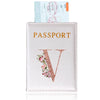 A pink leather passport holder with gold lettering and a rose gold initial design.