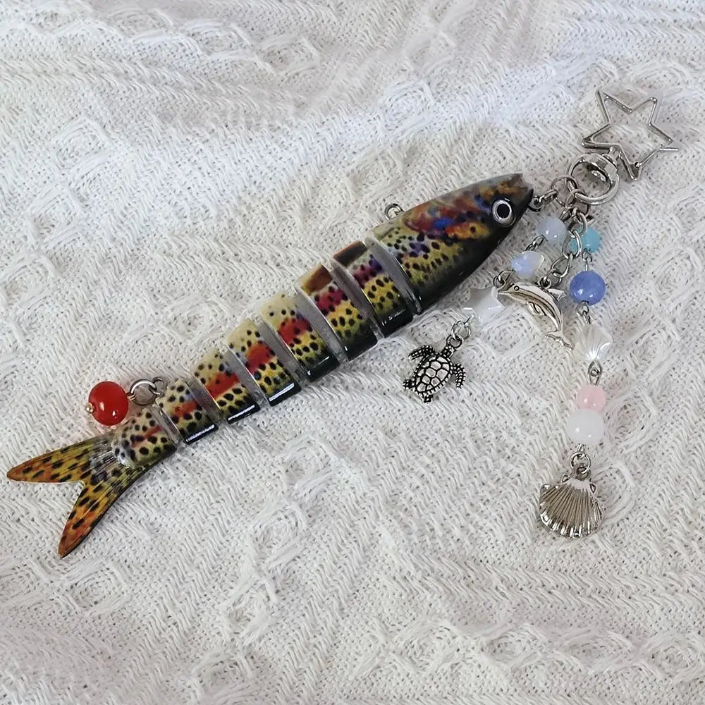 A colorful simulation fish keychain featuring scales and a silver star charm.