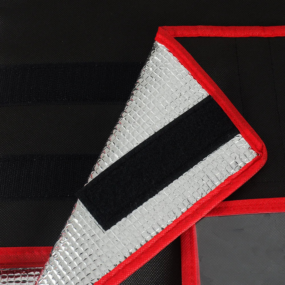 A triangular insulated pizza delivery bag with a silver foil lining and red trim on a black background.