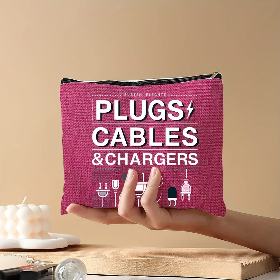 A hand holds a magenta zippered pouch labeled PLUGS CABLES & CHARGERS against a beige background.