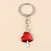 Silver chain keychain featuring a red heart pendant with a sun eye design.