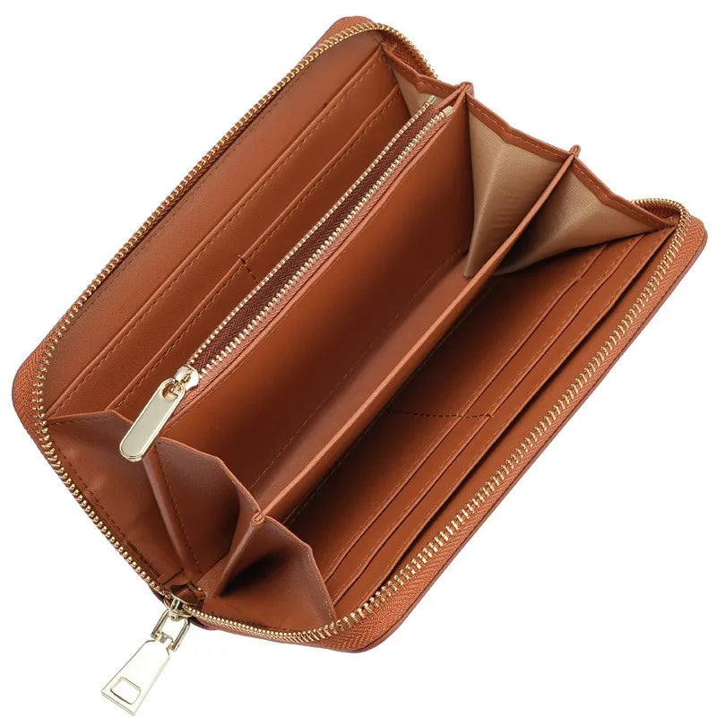 A brown genuine leather zipper wallet shown open, displaying the interior and stitching.