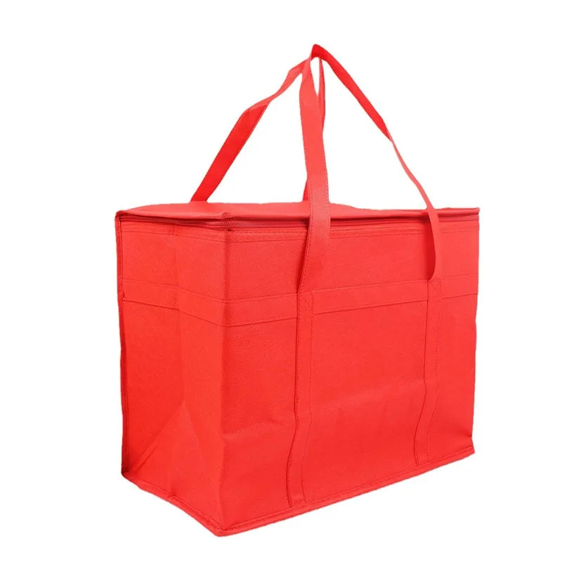 A bright red foldable insulated grocery and food cooler bag with carrying straps.