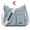 Graue wasserdichte Nylon-Crossbodytasche mit Riemen und mehreren Taschen.