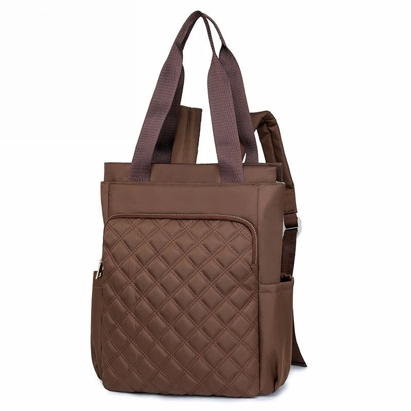 A brown quilted women's backpack tote with dark straps.