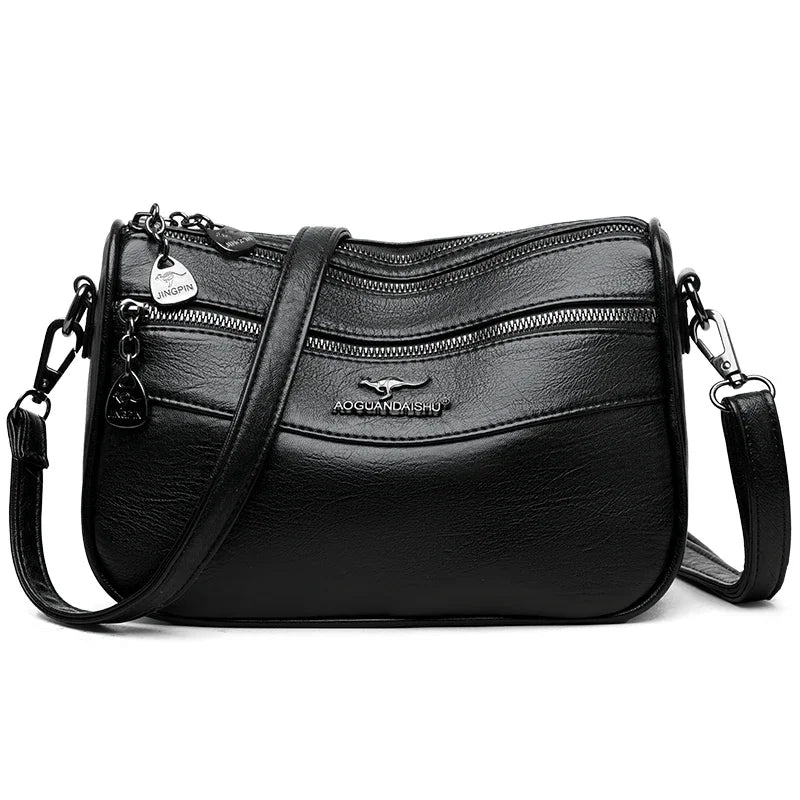 Bolso cruz de cuero negro y moderno para mujer con herrajes plateados