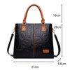 Sac bandoulière en cuir PU noir avec une poignée marron et des garnitures en cuir