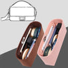 A pink felt bag insert organizer showing various stationery and accessories inside a rectangular pouch.