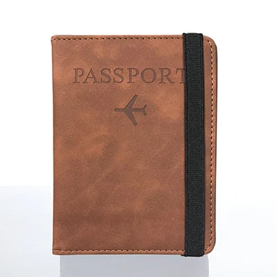 A brown leather passport organizer with a black strap and embossed text on the cover.