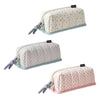 A light pink pencil case with a white dot pattern and gray fabric ties.