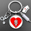 Silver keychain featuring a heart design with a nurse symbol and a medical instrument charm
