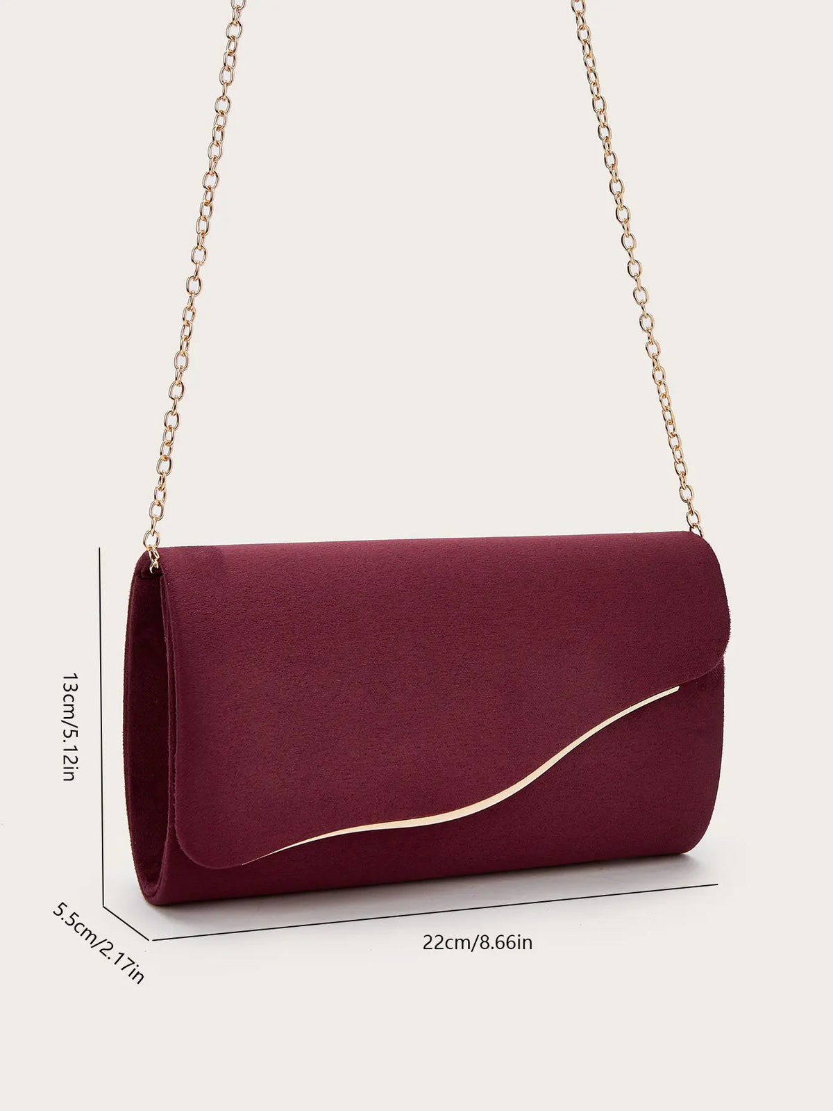 A deep burgundy velvet evening clutch with a gold chain strap shown against a light background.