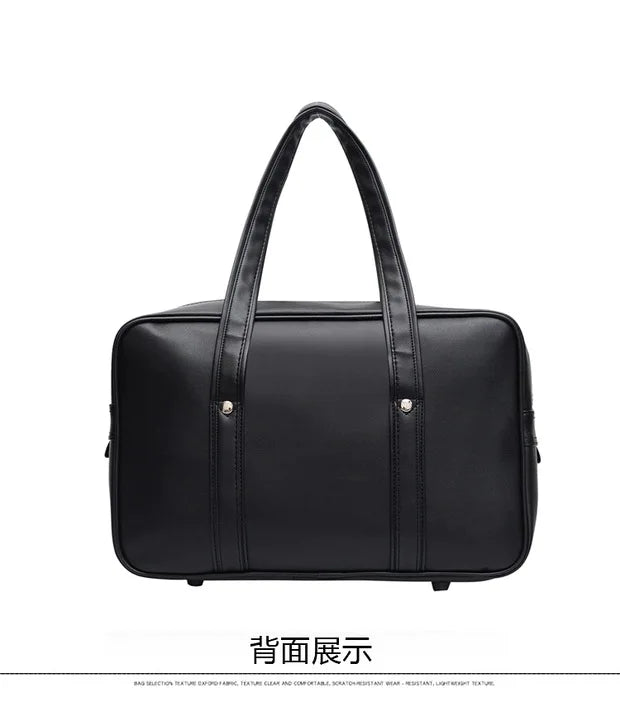 Black leather shoulder bag with a handle shown from the back