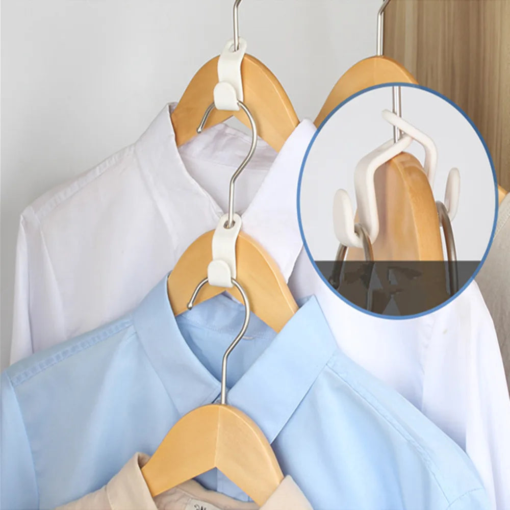 A wooden multi-hook wardrobe organizer displaying white and light blue shirts on hangers.