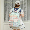 A woman wearing a white dress is shown from the back carrying a light blue and pink Candy Color Campus backpack.