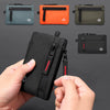 A hand holds a black RFID blocking travel wallet with a carabiner, shown alongside various colored versions.