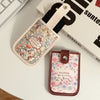 A floral patterned PU card wallet with a leather strap and a matching card holder is displayed on a white surface.