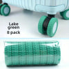 A set of eight lake green travel luggage wheel protectors packaged in a clear plastic bag.