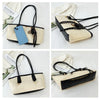 A classic beige and black PU leather tote bag with black leather trim and gold hardware.
