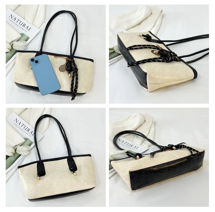 A classic beige and black PU leather tote bag with black leather trim and gold hardware.