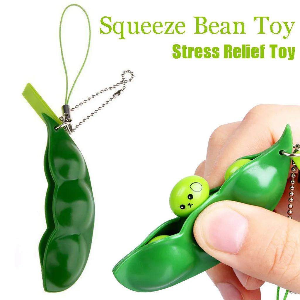 A green squeeze bean toy stress relief fidget toy attached to a keychain, held by a hand.
