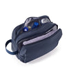 A navy blue large capacity multifunction cosmetic toiletry bag with a zippered compartment open to show various toiletries.