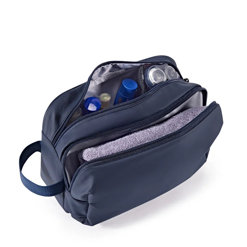 A navy blue large capacity multifunction cosmetic toiletry bag with a zippered compartment open to show various toiletries.