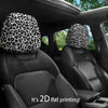 Black car seats with leopard print headrest covers installed in the vehicle interior.