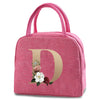 A pink insulated canvas lunch bag featuring a gold letter D design with floral accents.