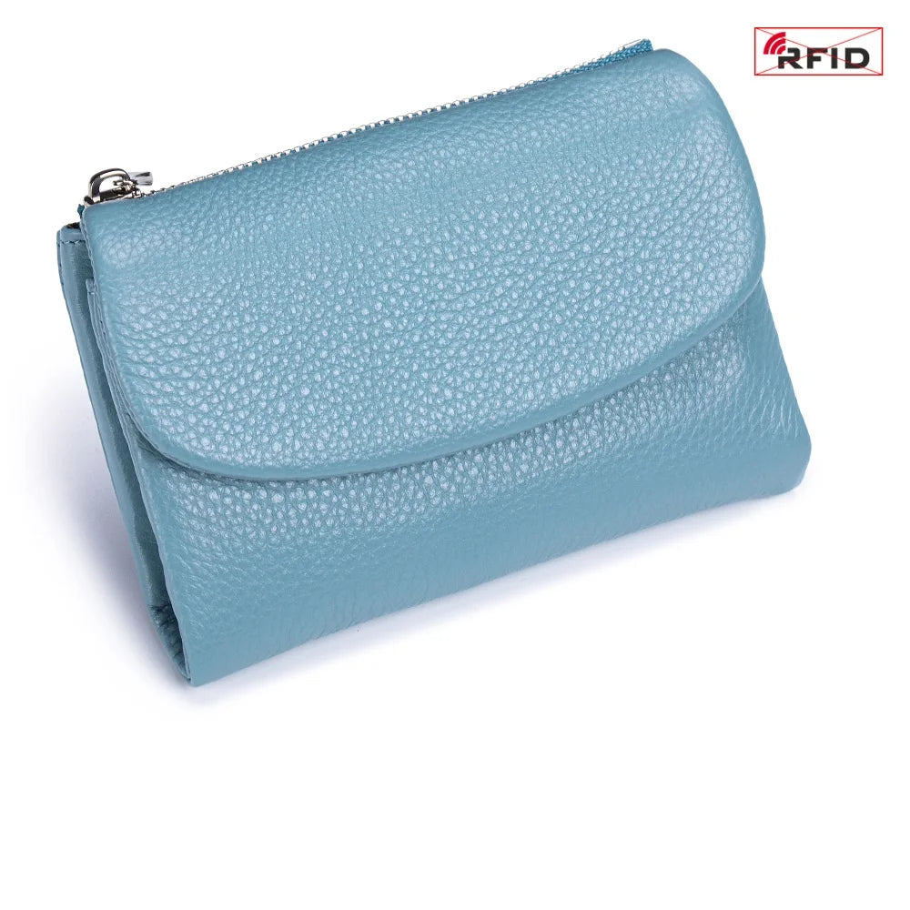A light blue genuine leather mini card holder wallet with a zipper closure.